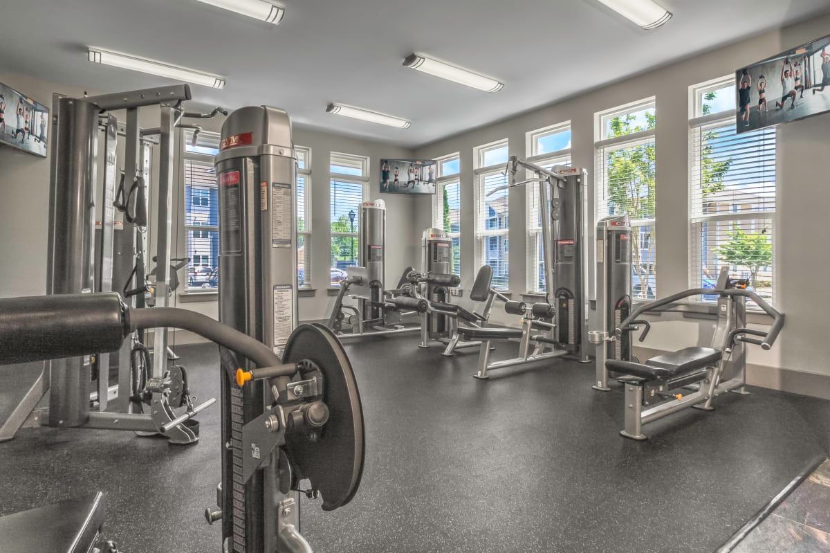 Gym interior with weight machines, rubber floor, and windows at Willows at Fort Mill, offers 1,2, and 3 bedroom apartments near Uptown Charlotte in Fort Mill, SC.