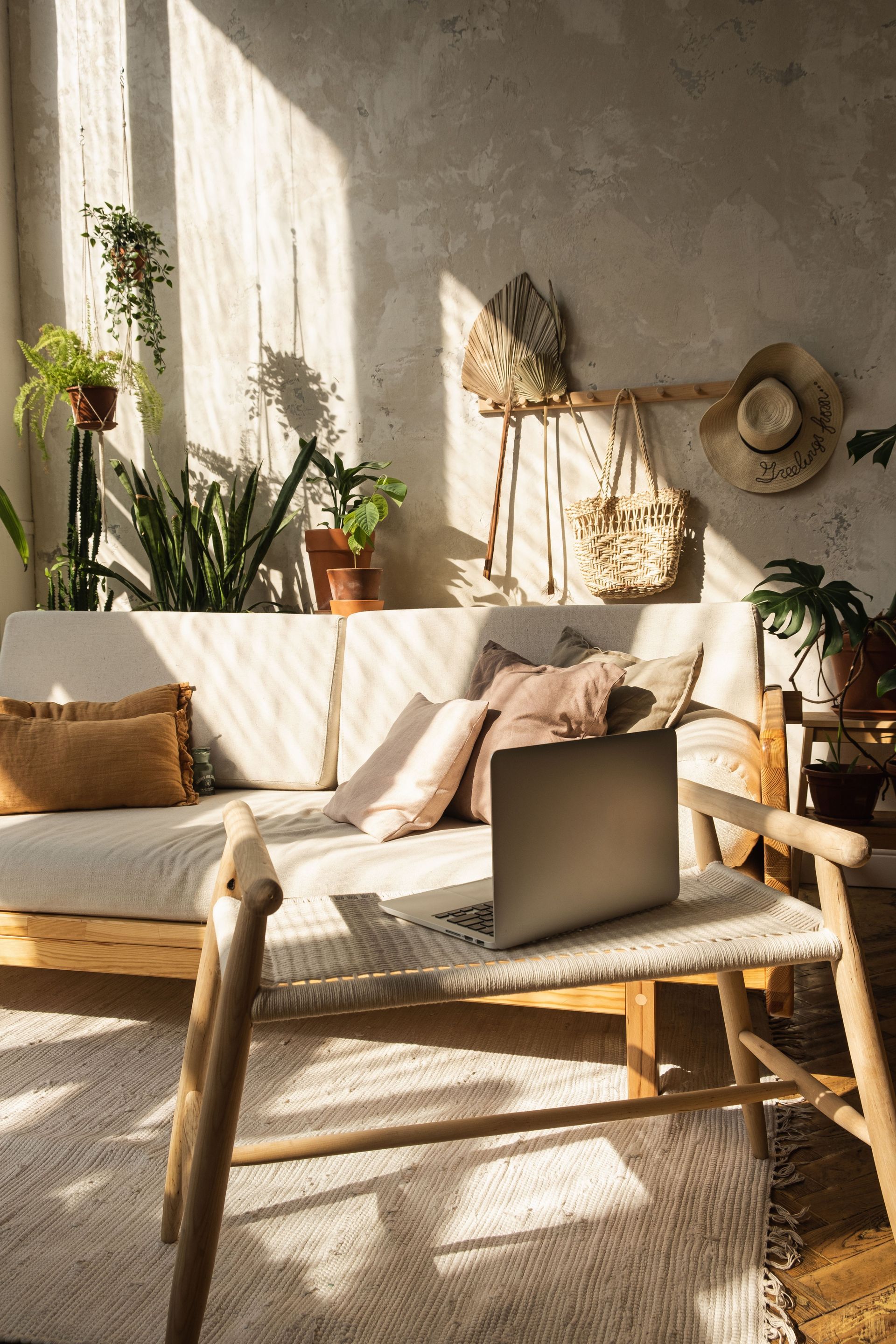 A laptop is sitting on a table next to a couch in a living room.