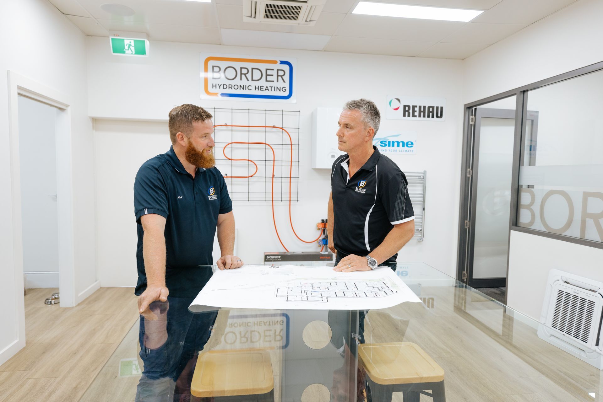 Border heating & cooling installation team discussing plans
