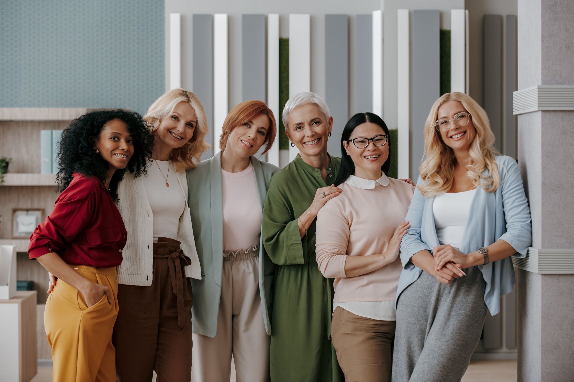 A group of women are posing for a picture together.