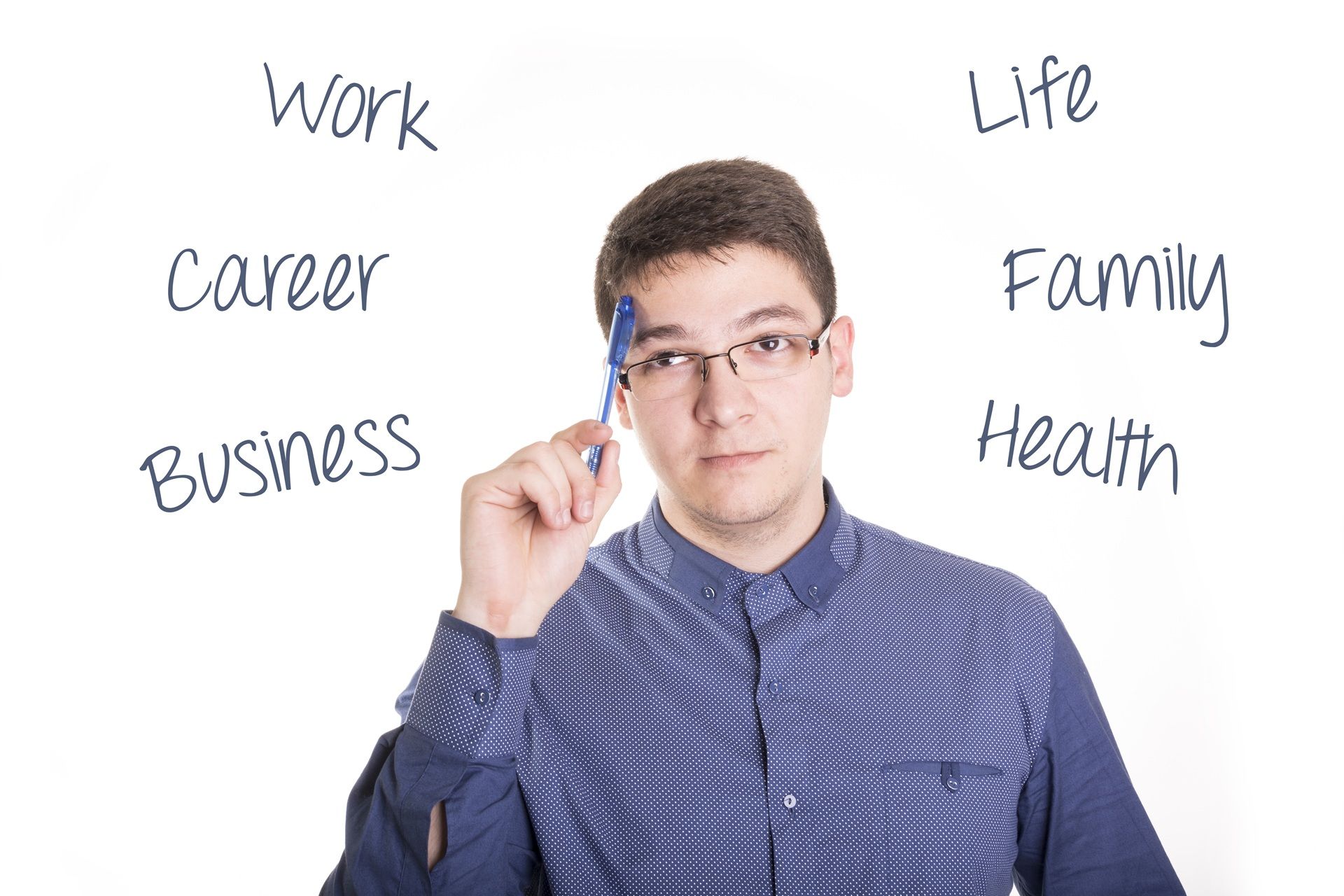 A young man is writing on a whiteboard with a pen.