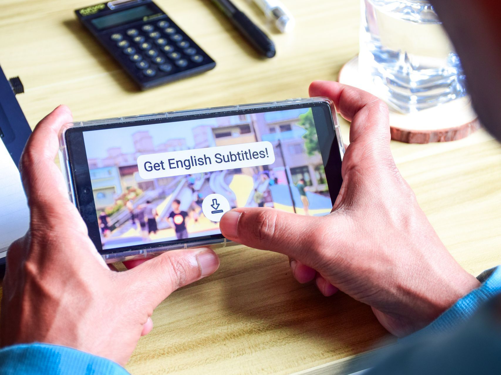 A person is holding a cell phone in their hands and playing a game on it.