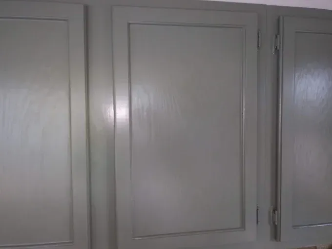 Three gray kitchen cabinet doors.