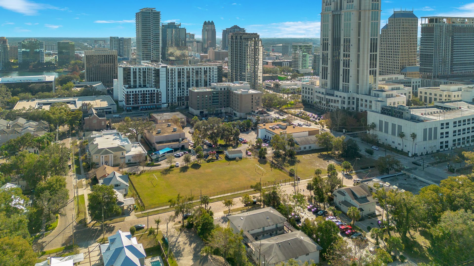 An aerial view of a city with lots of buildings and trees.