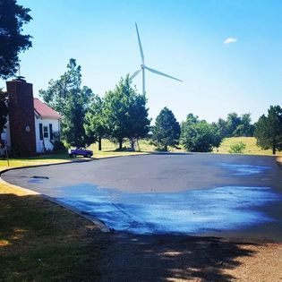A Pool of Water with a Windmill in the Background — Midwest City, OK — MPSC