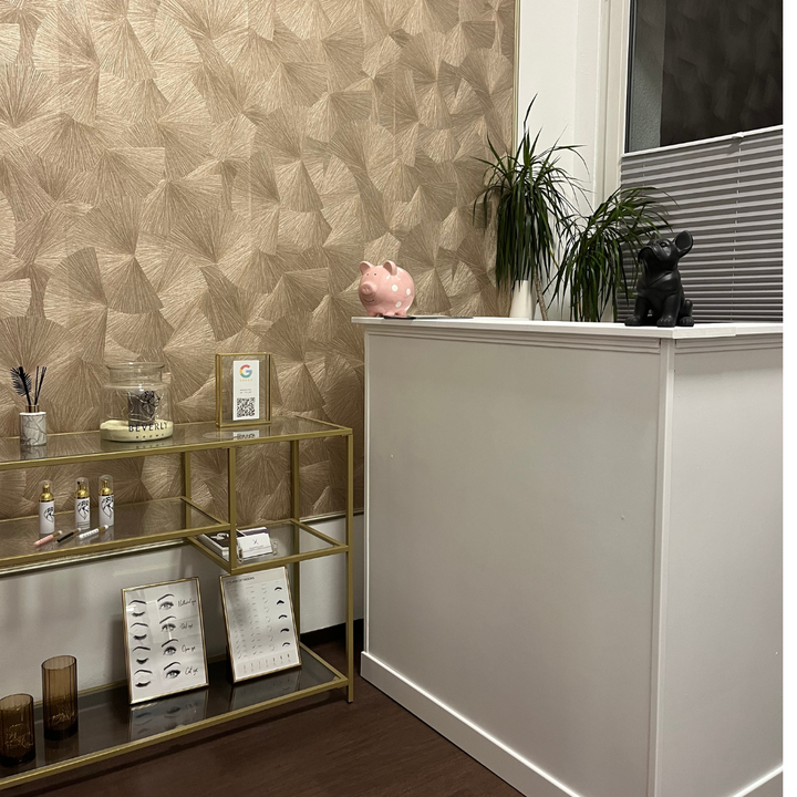 A room with a desk and a shelf with a piggy bank on top of it.