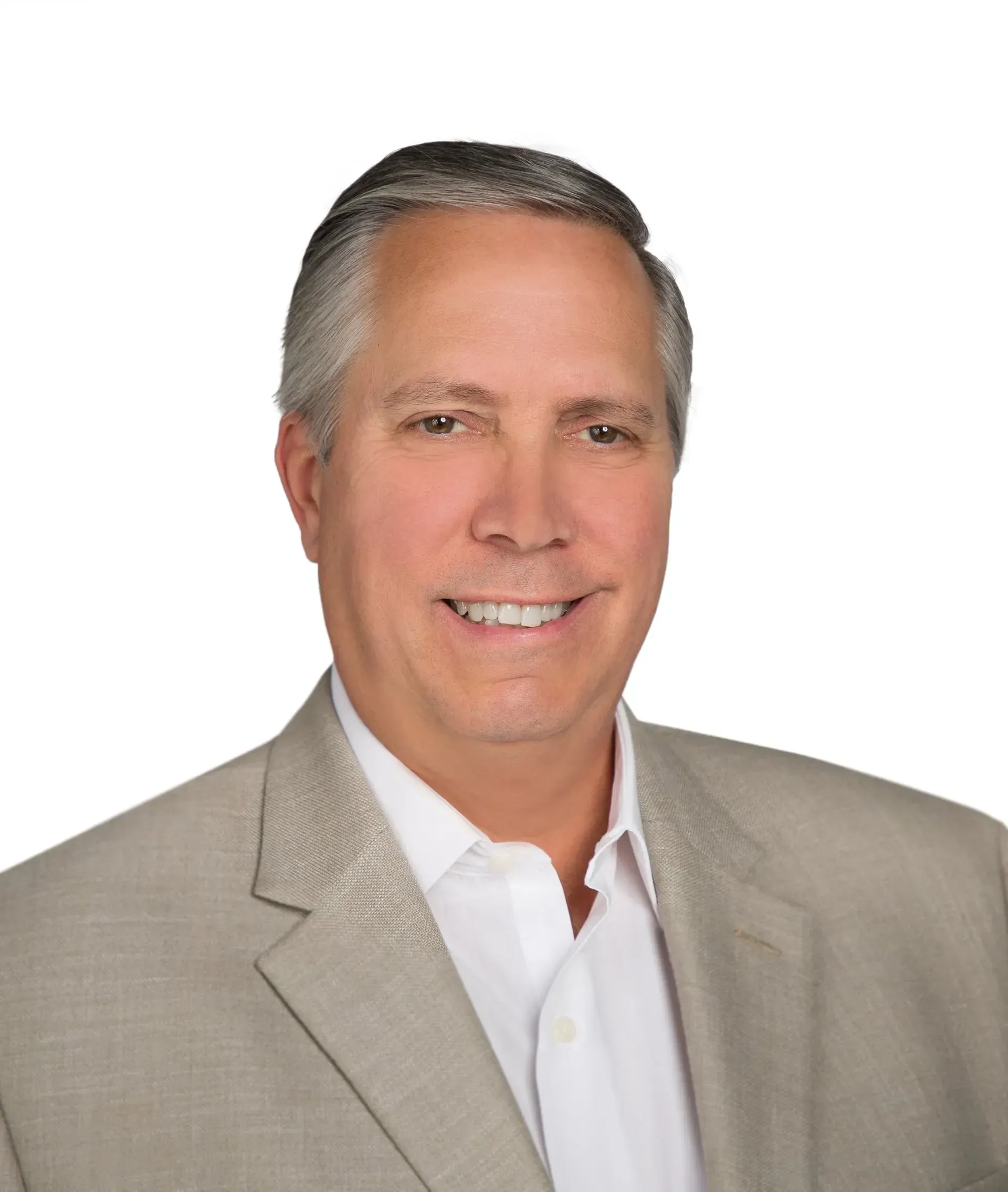 A man in a suit and white shirt is smiling for the camera.