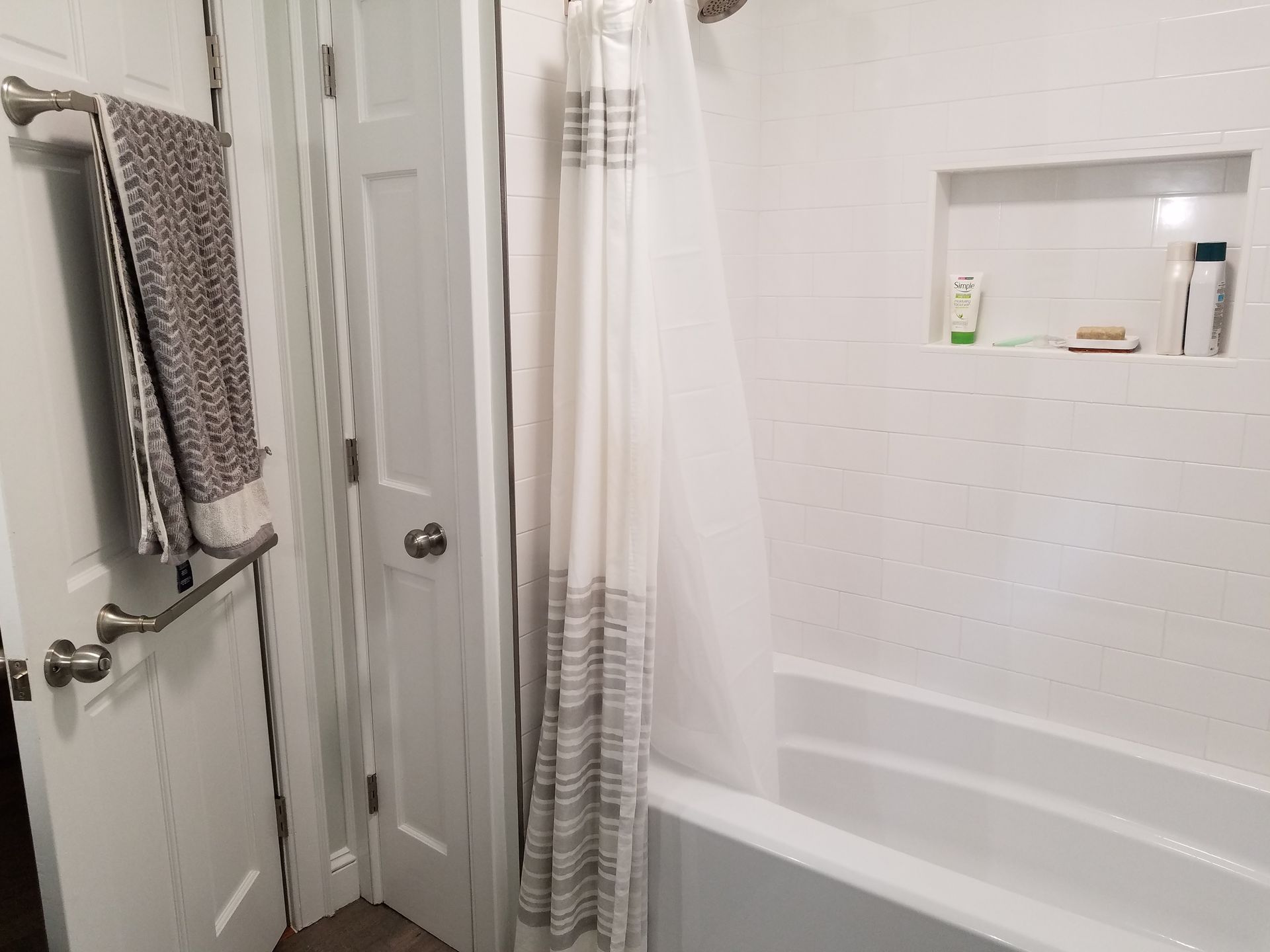 A bathroom with a shower curtain and a bathtub.