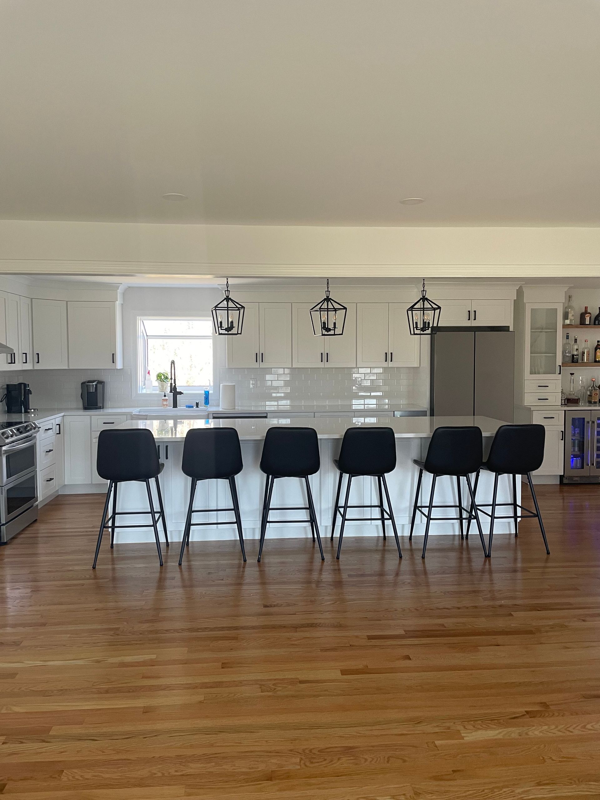 A kitchen with a large island and stools