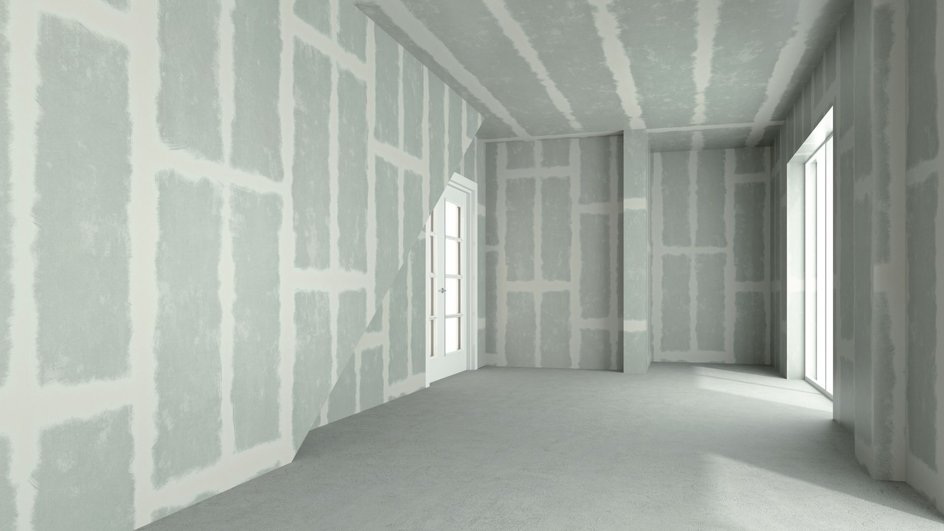 An empty room with drywall on the walls and ceiling.