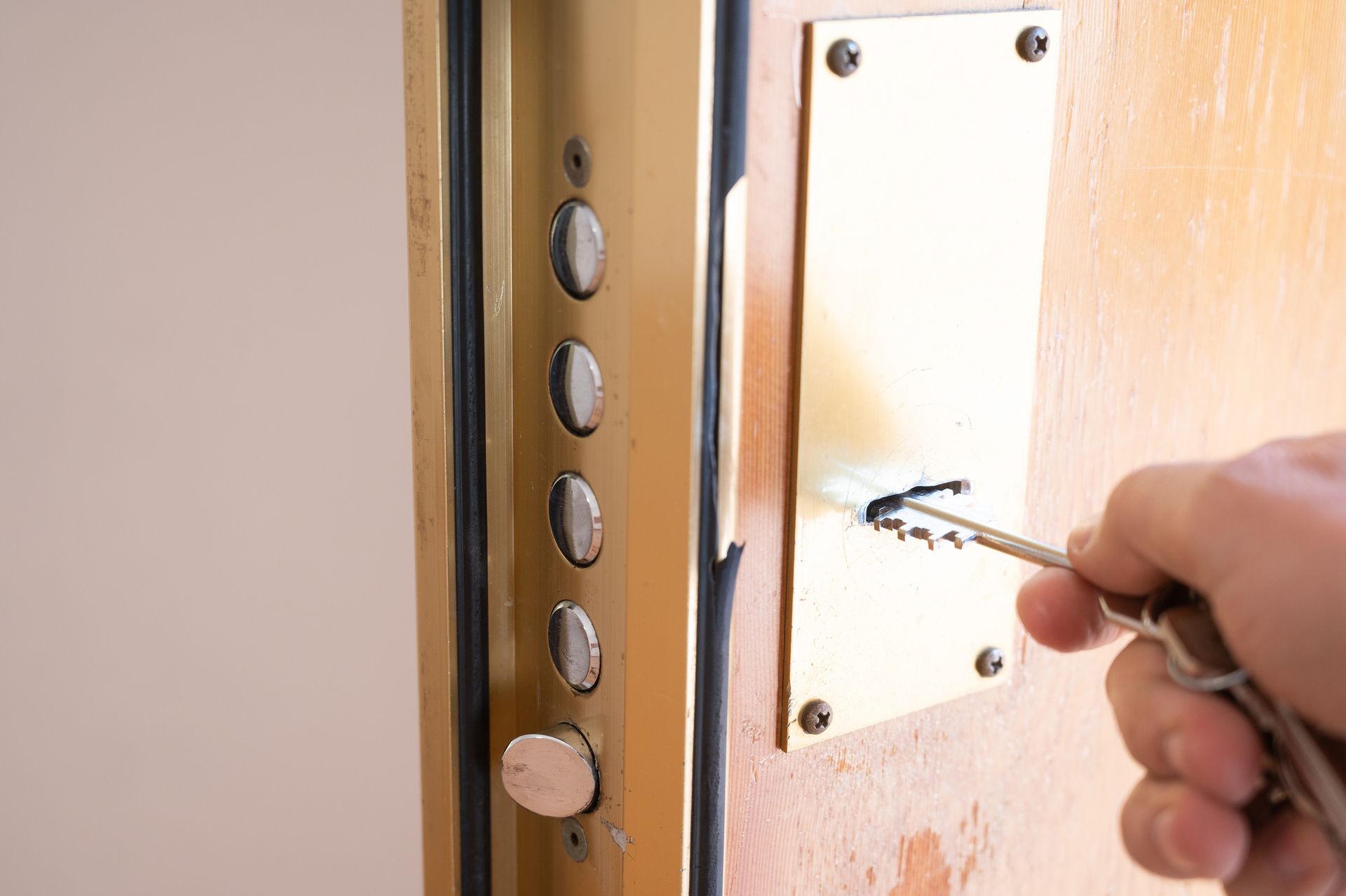 A person is using a key to open a door.