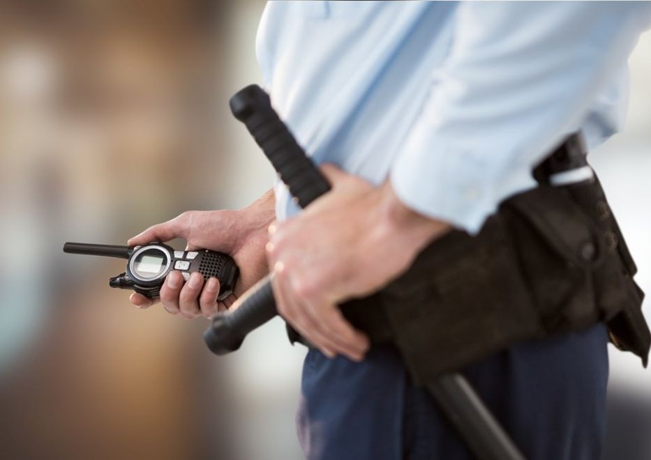 security professional holding a walkie talkie