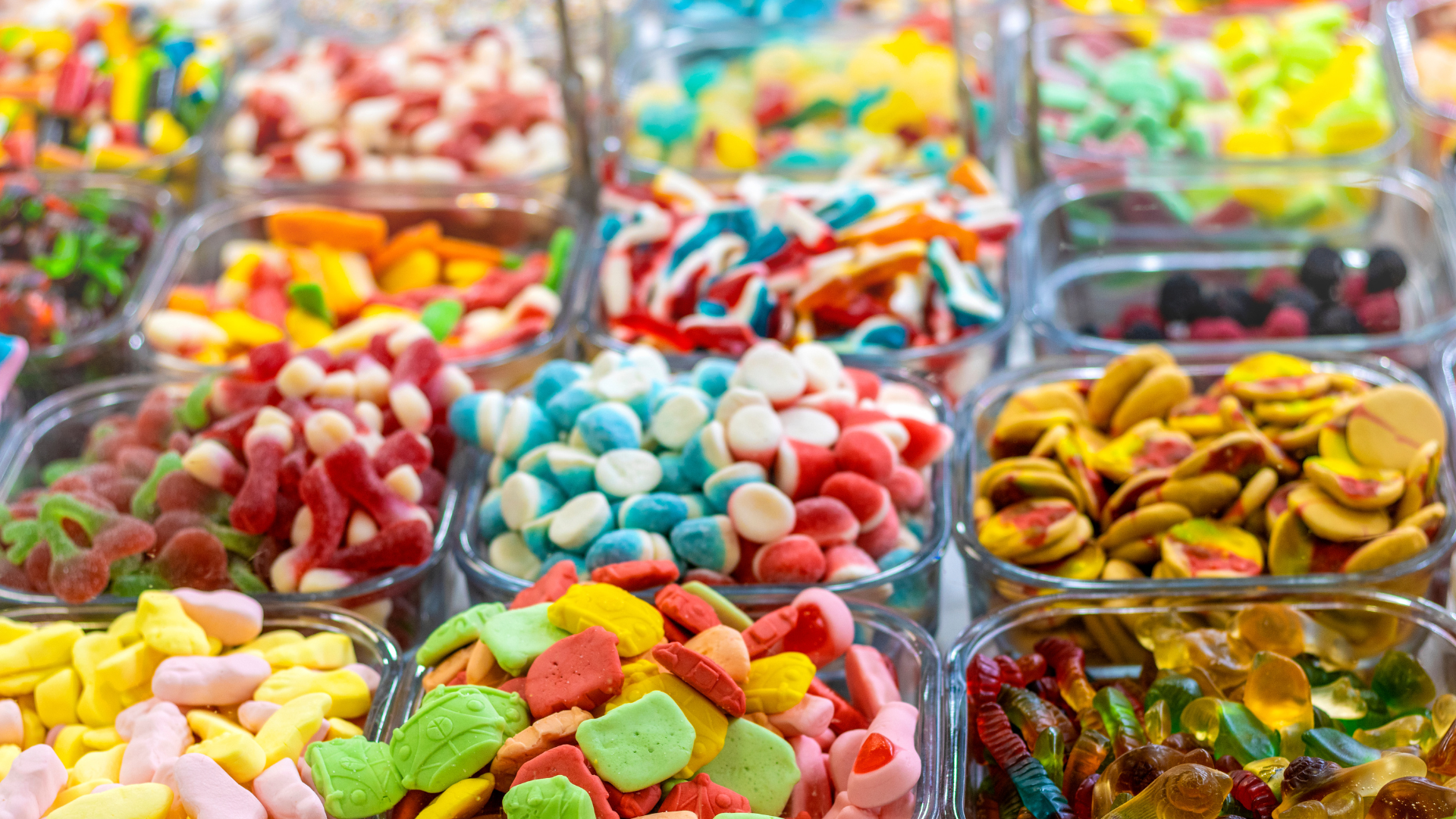 There are many different types of candy in the bowls.