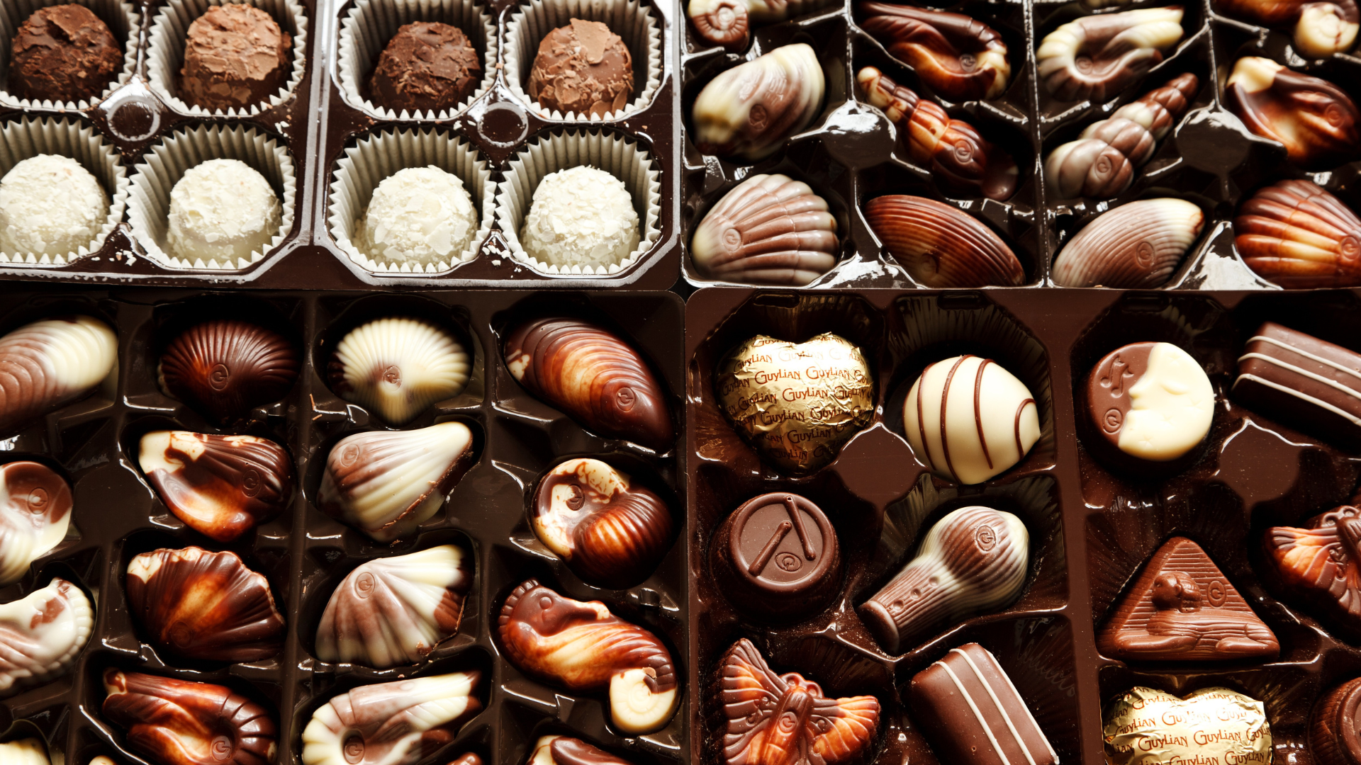 Several boxes of chocolates are lined up on a table