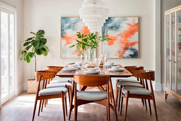 A dining room with a table and chairs and a chandelier.