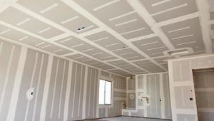 An empty room with drywall on the walls and ceiling.