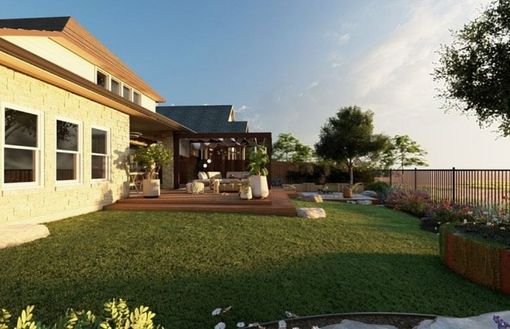 Man spreading mulch in a yard near a house with a brick patio and a wooden fence.