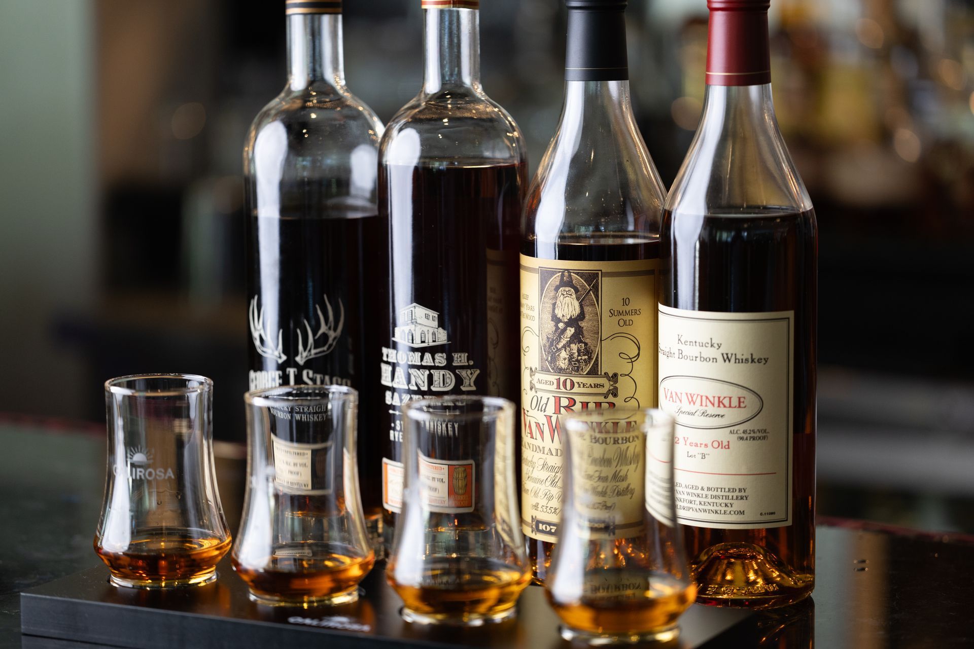 Bottles of whiskey and shot glasses on a table