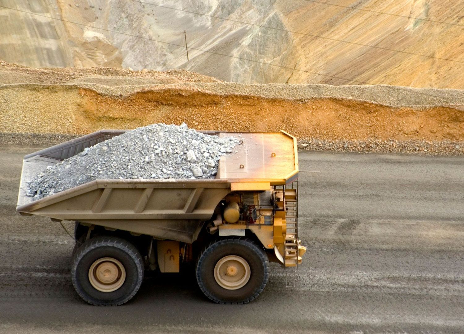 A Dump Truck Is Driving Down A Road — Welch, MN — Luhman's Construction Co.
