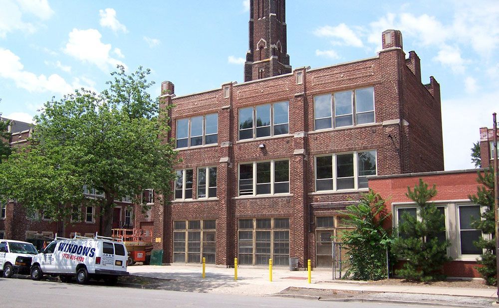 A brick building with a white van parked in front of it