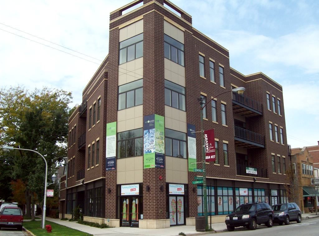 A large brick building with cars parked in front of it