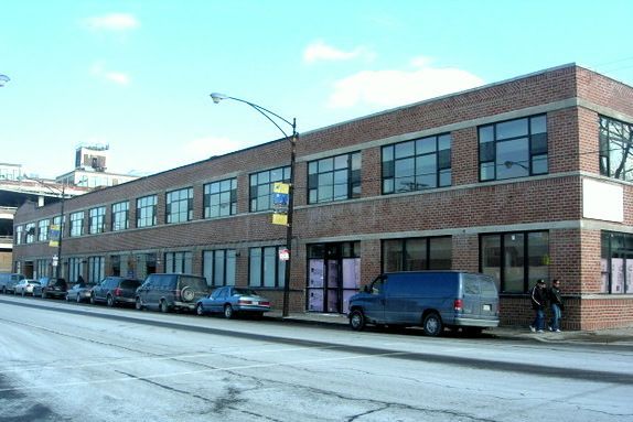A large brick building with cars parked in front of it