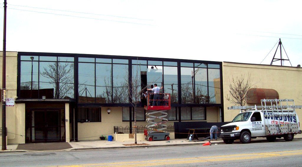 A white van with the word wiper on it is parked in front of a building