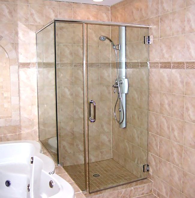 A bathroom with a tub and a shower with a glass door