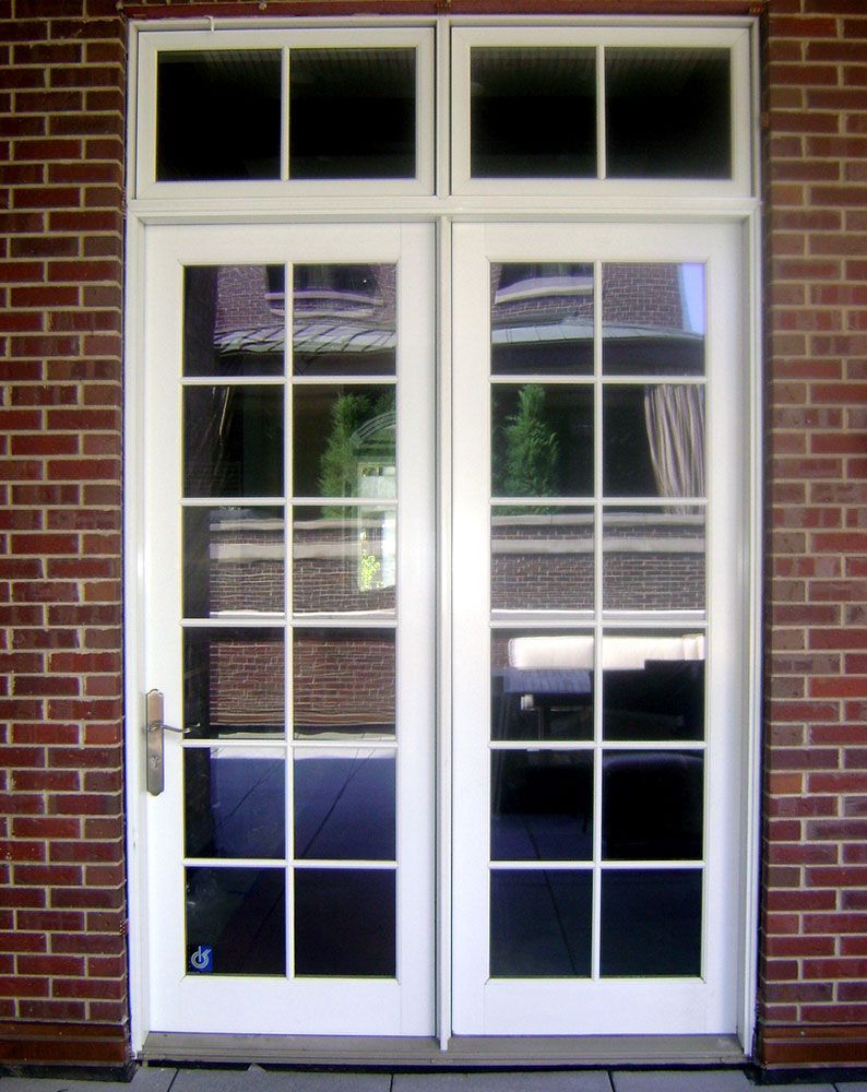 A white door with a brick wall behind it