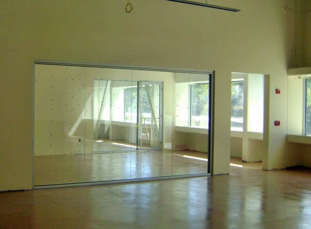 An empty room with a large mirror on the wall