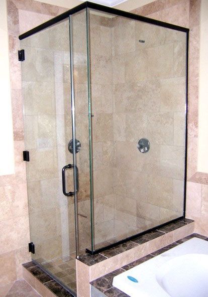 A bathroom with a walk in shower and a bathtub