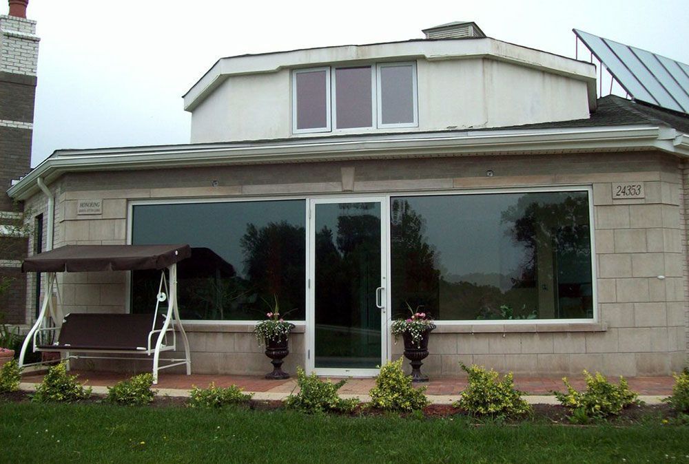 A house with a swing in front of it and a sliding glass door