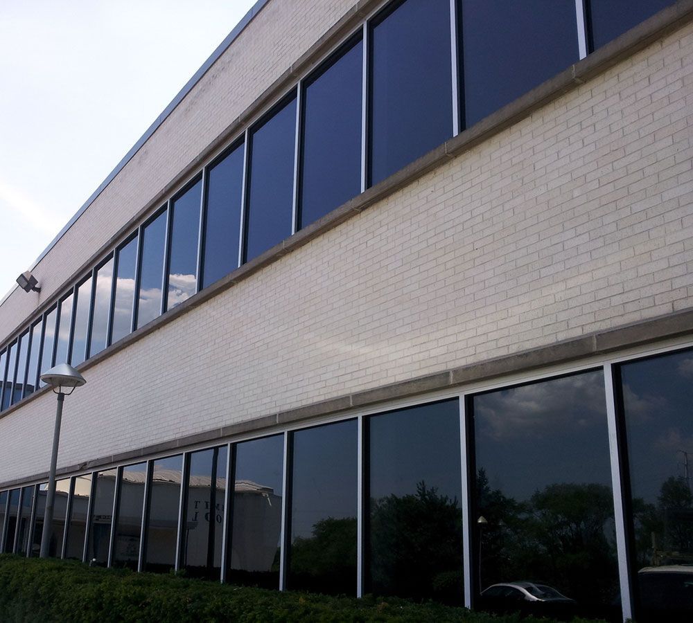 A large white brick building with lots of windows