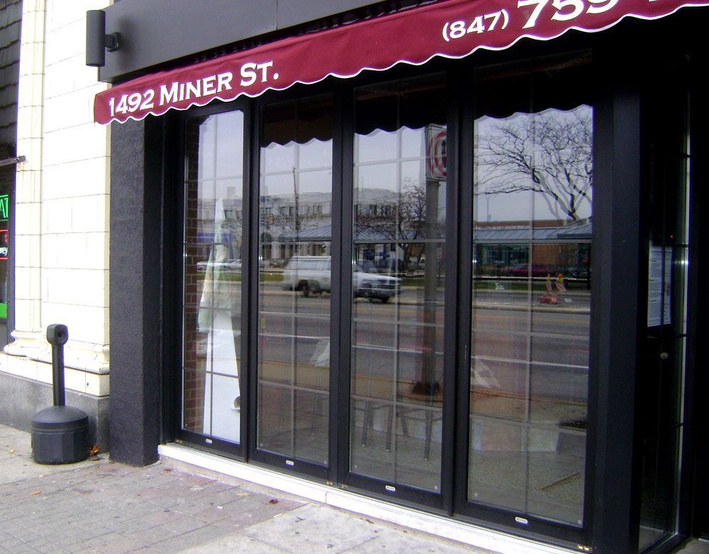 A store front with a red awning that says 1492 miner st.
