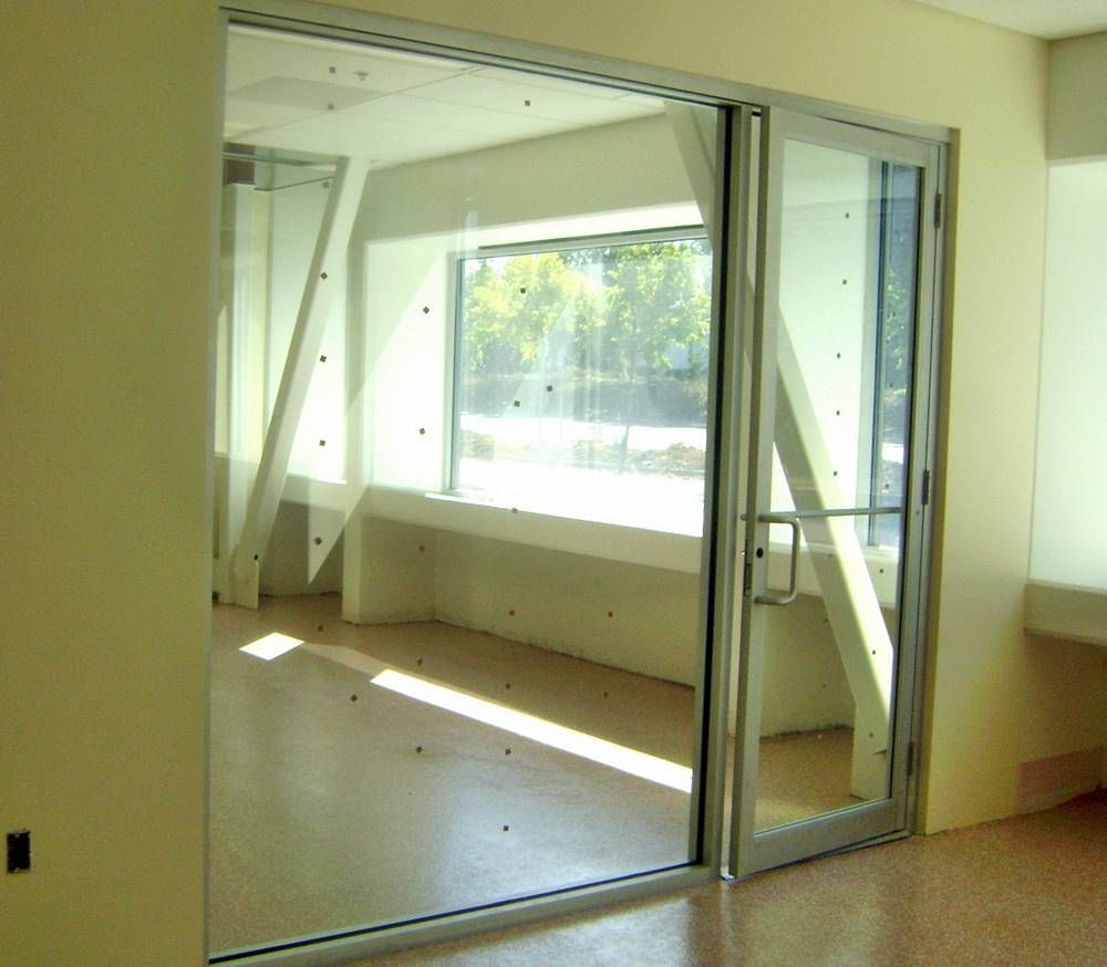 An empty room with a glass door and a window