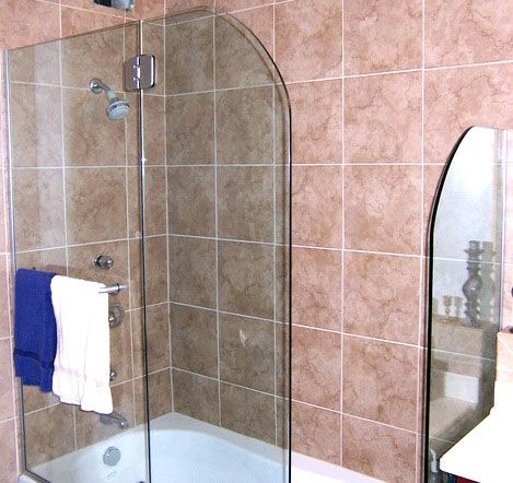 A bathroom with a bathtub and a shower with a glass door