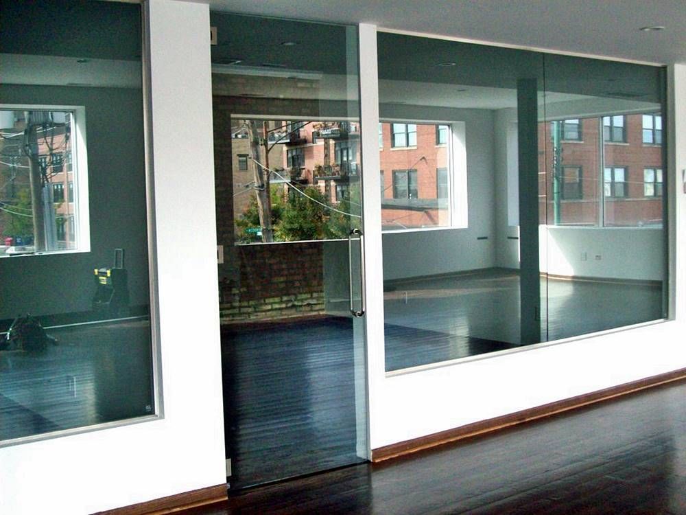 A room with a lot of windows and a door