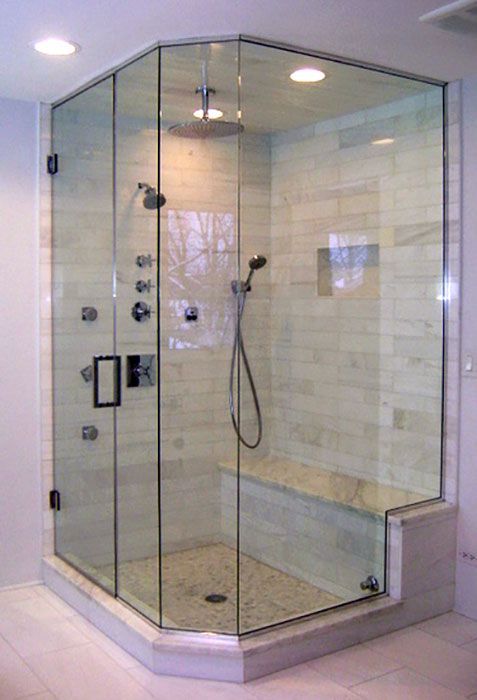 A shower stall with a bench and a shower head