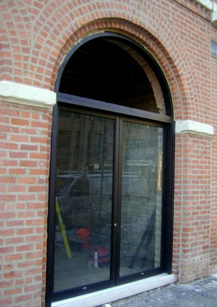 A brick building with a sliding glass door