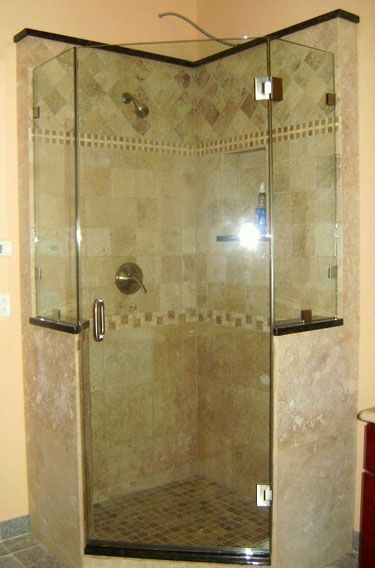 A shower stall with a glass door in a bathroom