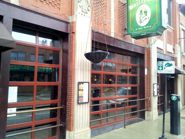A restaurant with a green sign that says ' basil ' on it