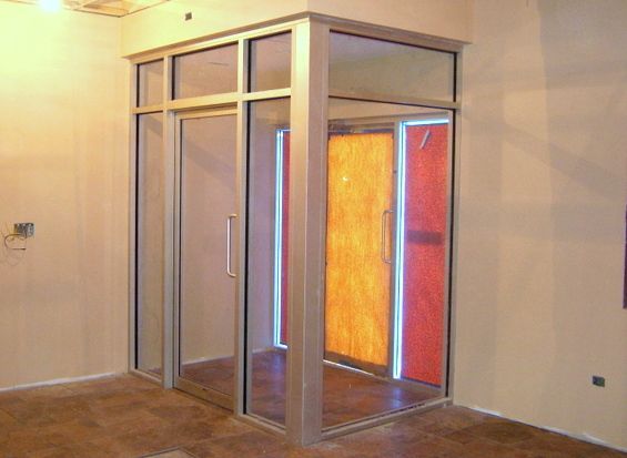 A room with a sliding glass door and a stained glass door
