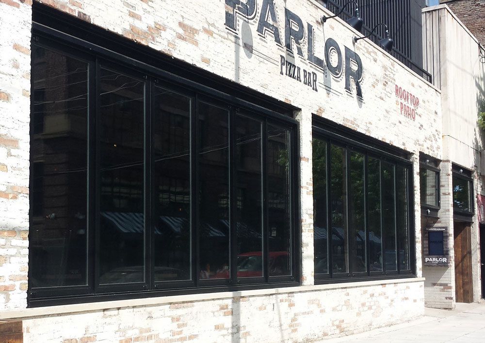 A building with a lot of windows and a sign that says parlor