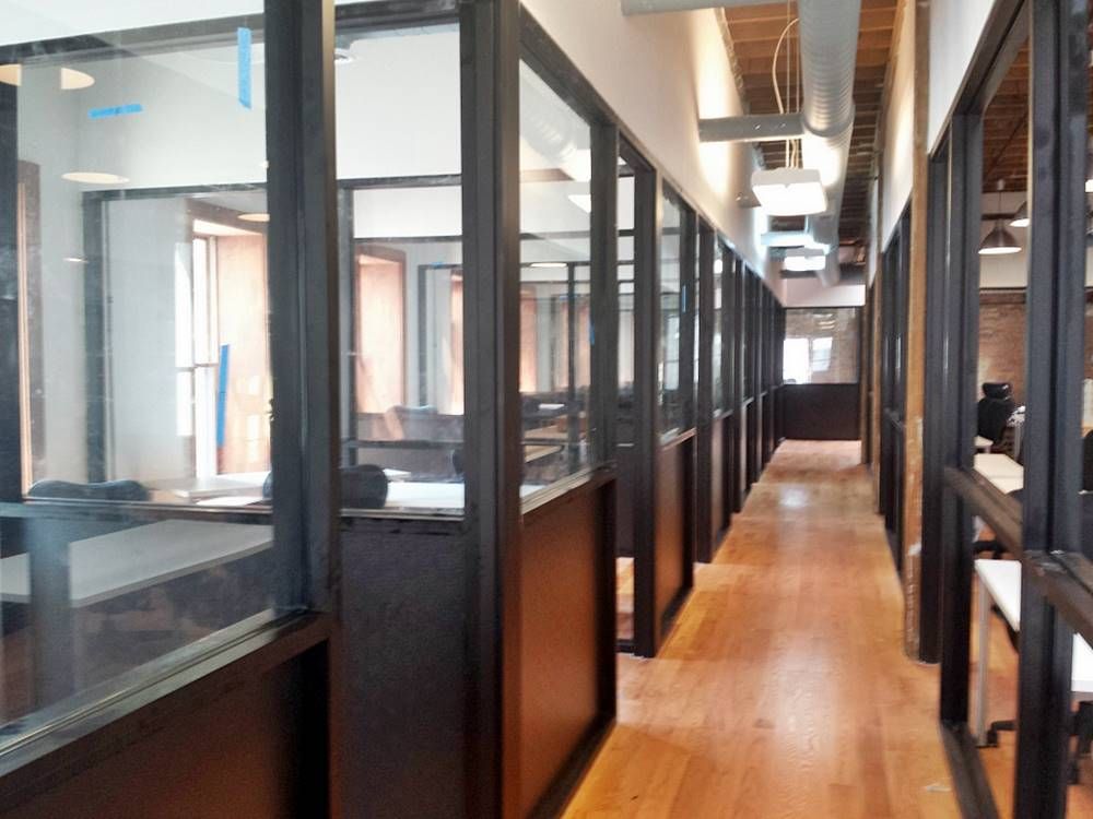 A long hallway in a building with a lot of windows