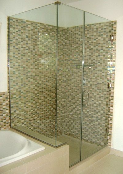 A bathroom with a walk in shower and a bathtub.