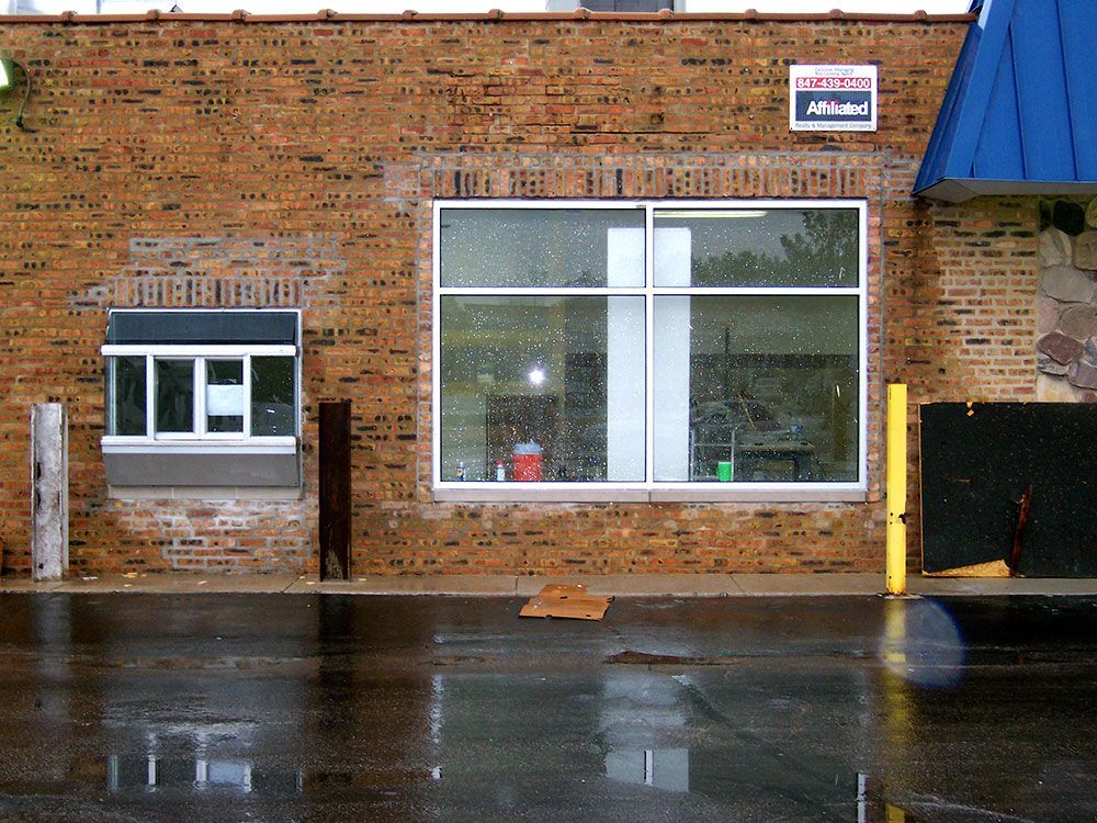 A brick building with a pepsi sign on the side