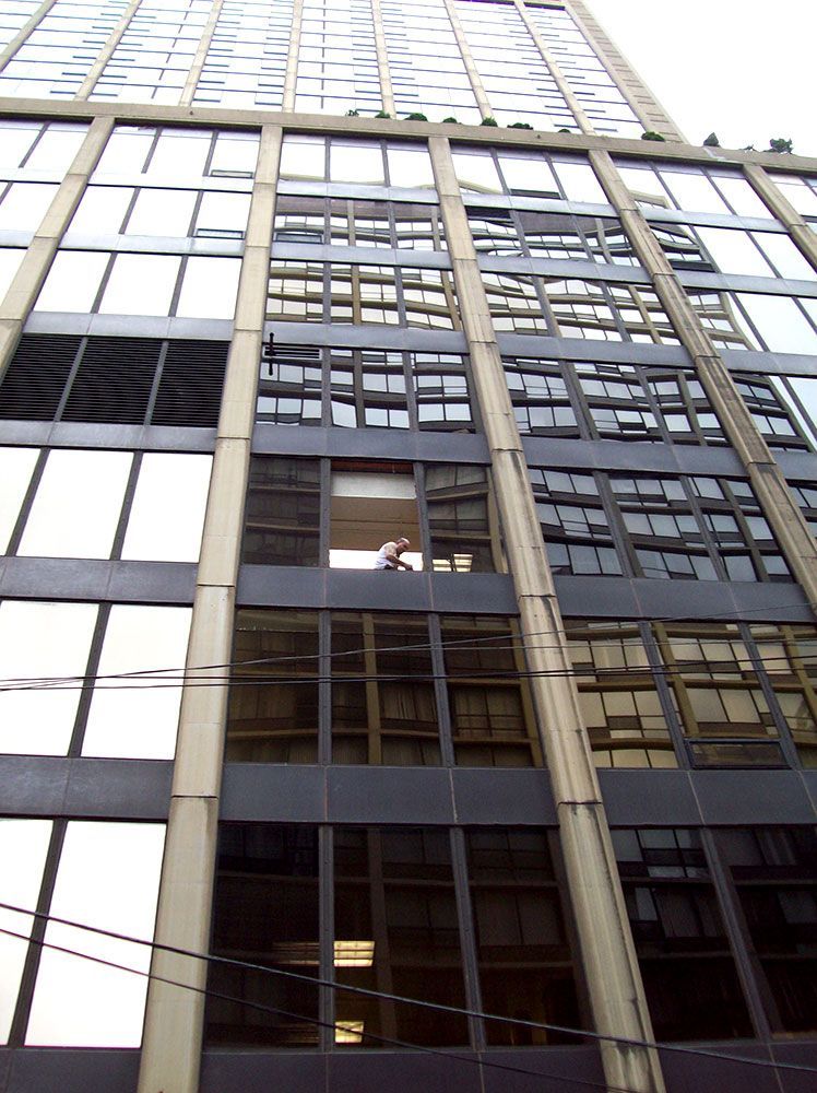 Looking up at a tall building with lots of windows