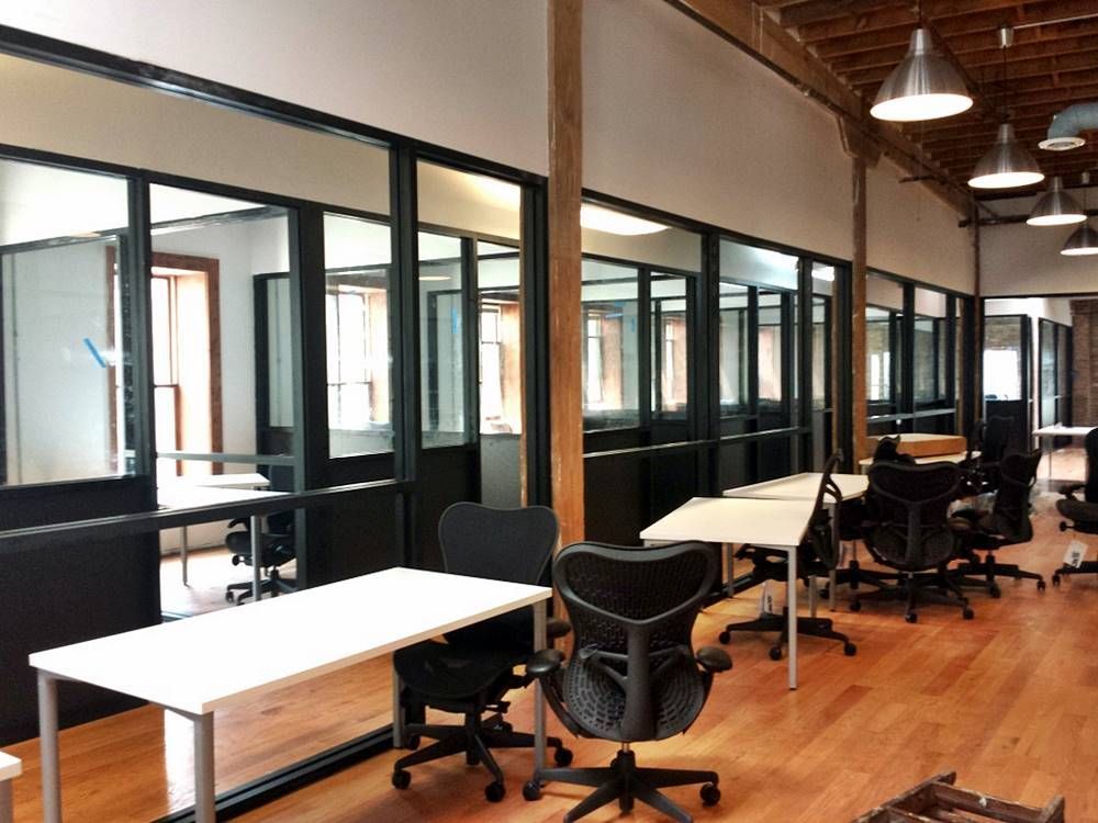 A large office with lots of tables and chairs