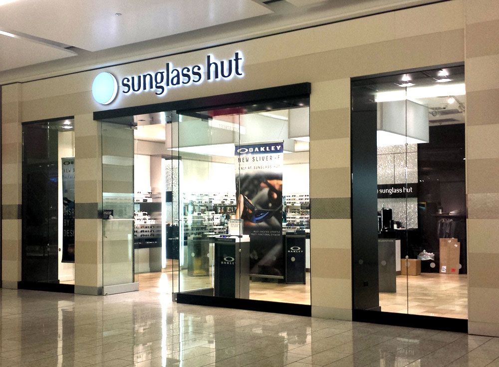 The outside of a sunglass hut store in a mall