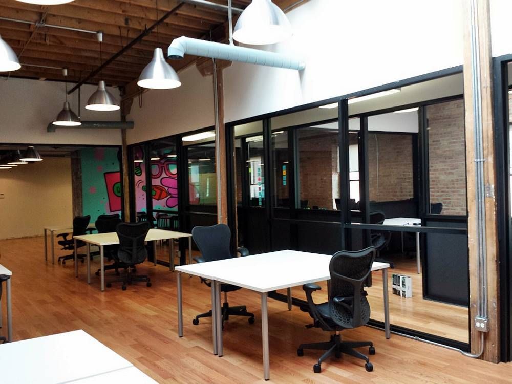 A room with a lot of tables and chairs in it